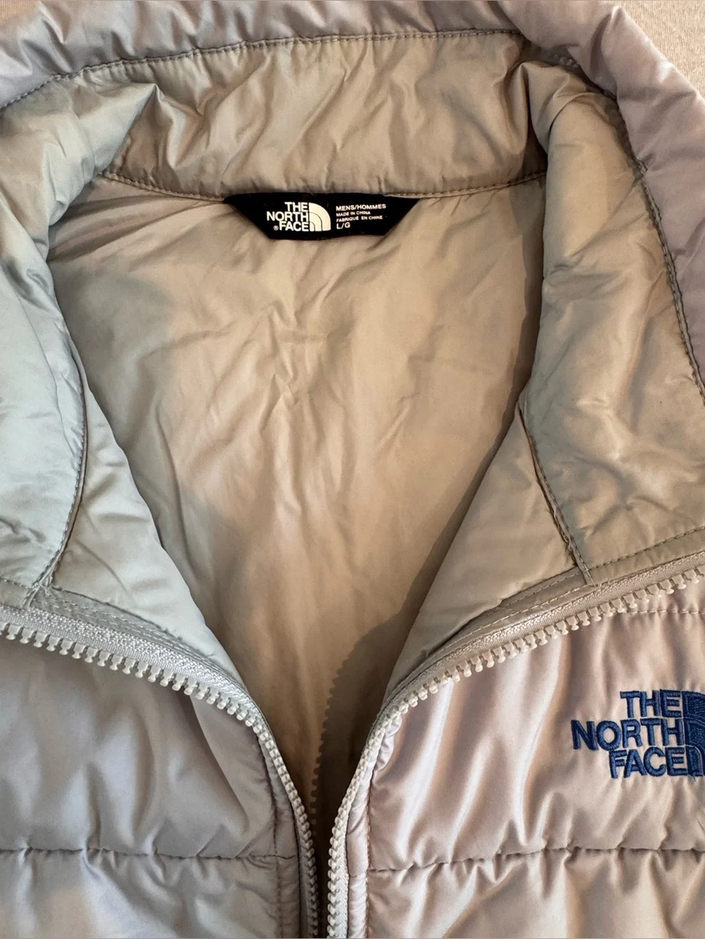 The North Face Light Gray Men's Puffer Jacket with Blue Accents